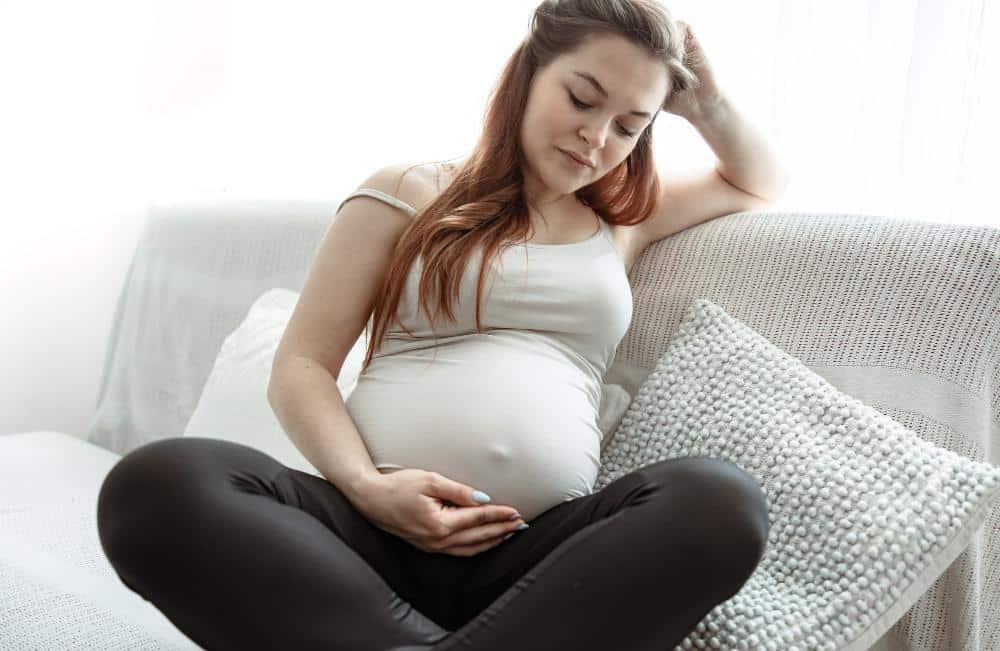 Pregnant woman suffering pain from hemorrhoids