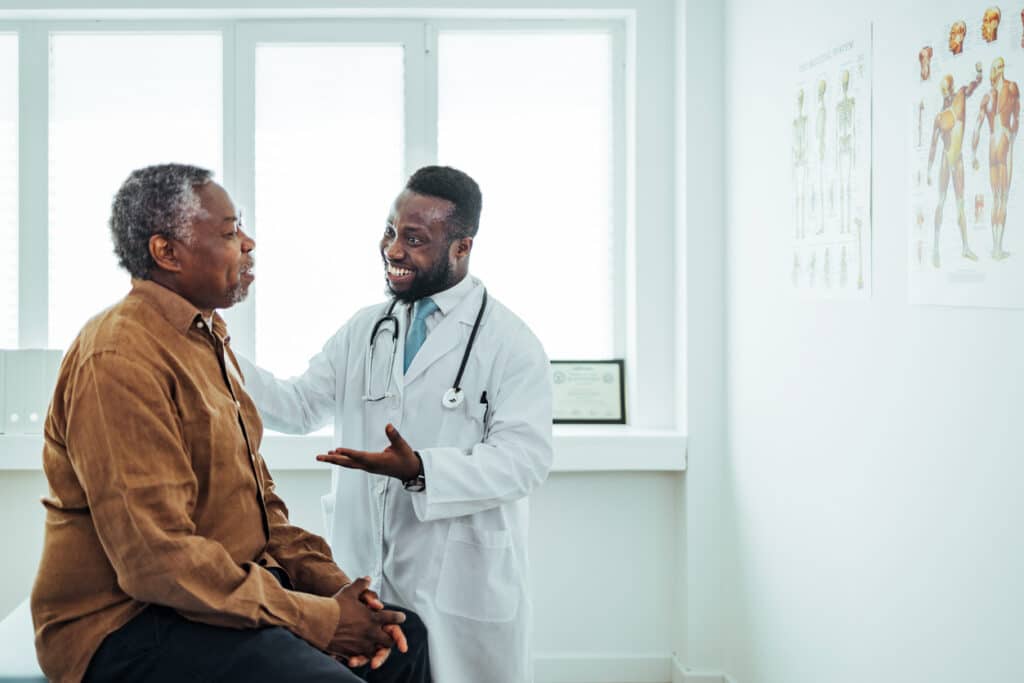 doctor speaking with an older male patient during a medical consultation