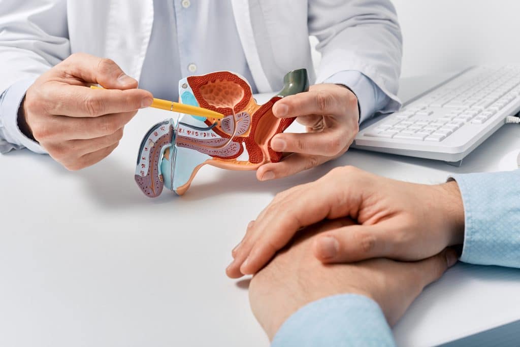 A doctor talking to a patient about prostate artery embolization in St. Louis