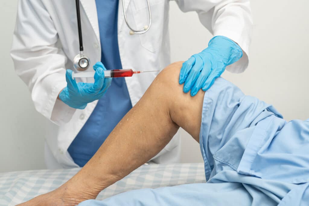 person getting prp injection in their knee